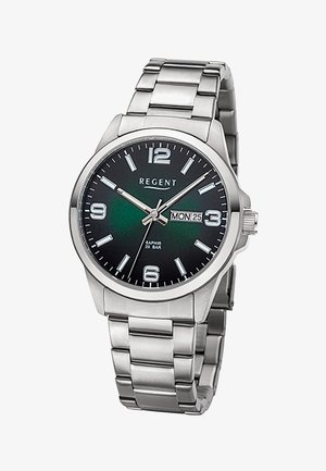 Montre-bracelet en métal argenté avec cadran noir, index argentés, affichage jour-date indiquant lundi 25, et marque REGENT sur le cadran.