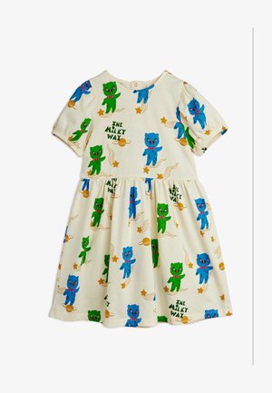 Kermanvärinen vauvan mekko, jossa on puffihihat ja vihreitä sekä sinisiä karhuja, tähtiä, planeettoja ja "The Milky Way" -tekstikuvio.