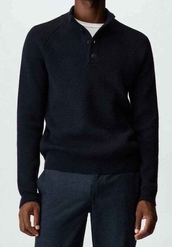 Navy ribbed knit sweater with a half-button placket, long sleeves, and a relaxed fit, paired with textured plaid trousers.