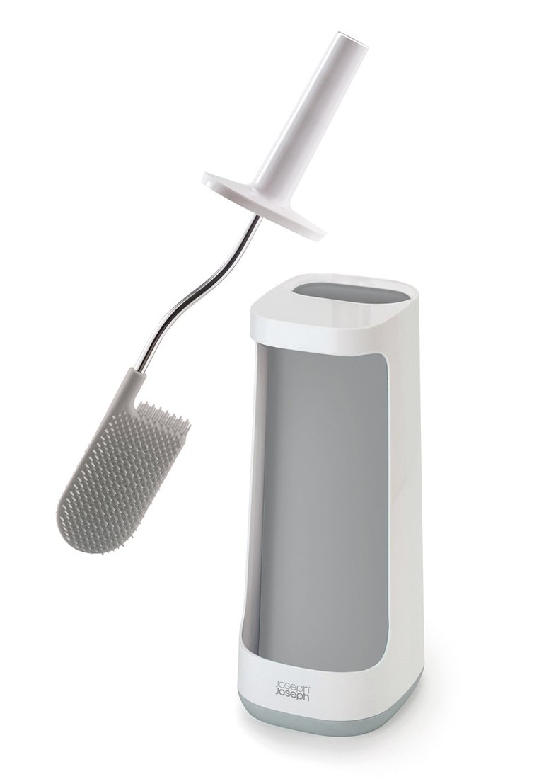 Toilettenbürste mit ergonomischem weißen Griff und flexiblen Silikonborsten, begleitet von einem eleganten, modernen Halter in Weiß und Grau.