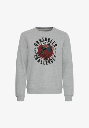 Szürke pulóver hosszú ujjakkal, amelyen egy panda kerékpáron látható grafikai nyomat és a "Az akadályok kihívások" felirat szerepel.