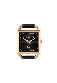 Montre rectangulaire Ted Baker avec un boîtier doré, un cadran noir et un bracelet en cuir noir. Présente un détail en forme de nœud à 6 heures et des index dorés.