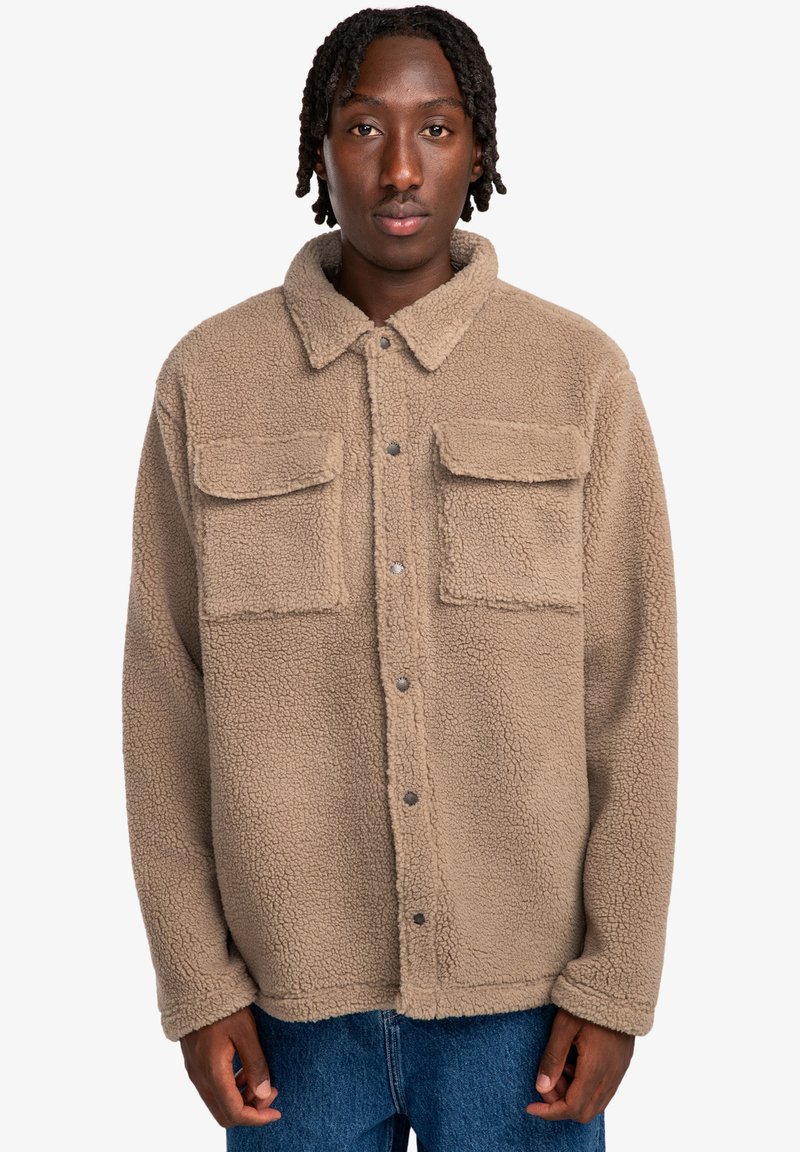 Brown fleece jacket with a collared neck, snap buttons, and two front pockets. Soft texture with a loose fit.