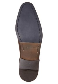Semelle de chaussure en cuir marron avec un design lisse et arrondi ; équipée d'une semelle en caoutchouc noir au talon et de coutures le long des bords.