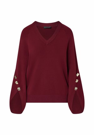 Jersey burdeos de manga larga con escote en V, mangas anchas y tres botones decorativos en cada puño.