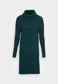 Vestito maglione di un verde scuro, con scollatura a cowl, maniche lunghe e dettagli a coste sui polsini e sull'orlo. Texture morbida.