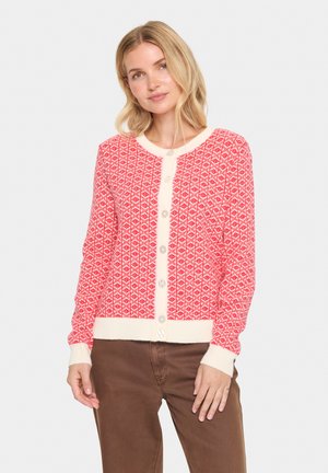 Red cardigan with diamond pattern, cream accents, and button front. Ribbed cuffs and hem. Lightweight knit fabric.
