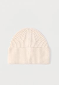 Knit beanie made of soft cream-colored fabric, featuring vertical ribbing, a folded cuff, and a seamless top for a snug fit.