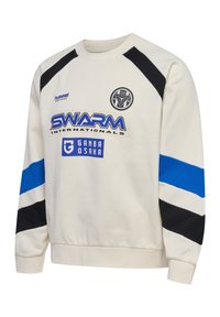 Krämfärgad sweatshirt med svarta axelinsatser, blå och svarta ränder, samt grafiska logotyper. Tillverkad av mjukt tyg, med ribbade muddar och nederkant.