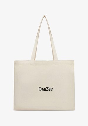 Beige lærredsnettaske med lange håndtag og "DeeZee"-logo trykt i sort centreret på forsiden.