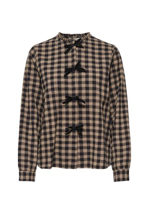 Blouse à manches longues beige et noire à carreaux avec quatre nœuds en velours noir sur le devant et un petit col à volants.