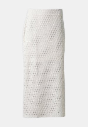 Fustă creion albă, până la genunchi, dintr-un material texturat, prezentând decupaje pătrate distribuite uniform. Proiectată cu o siluetă ajustată.