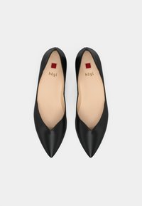 Black leather ballet flats with a pointed toe design, featuring a smooth texture and a beige interior with logo detailing.
