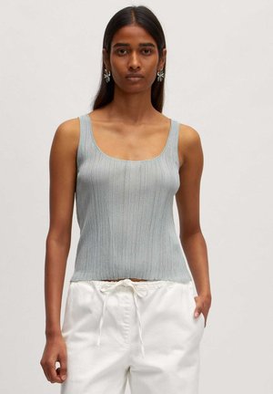 Ribbed light blue sleeveless top with a square neckline, paired with white drawstring pants. Smooth texture, fitted design.
