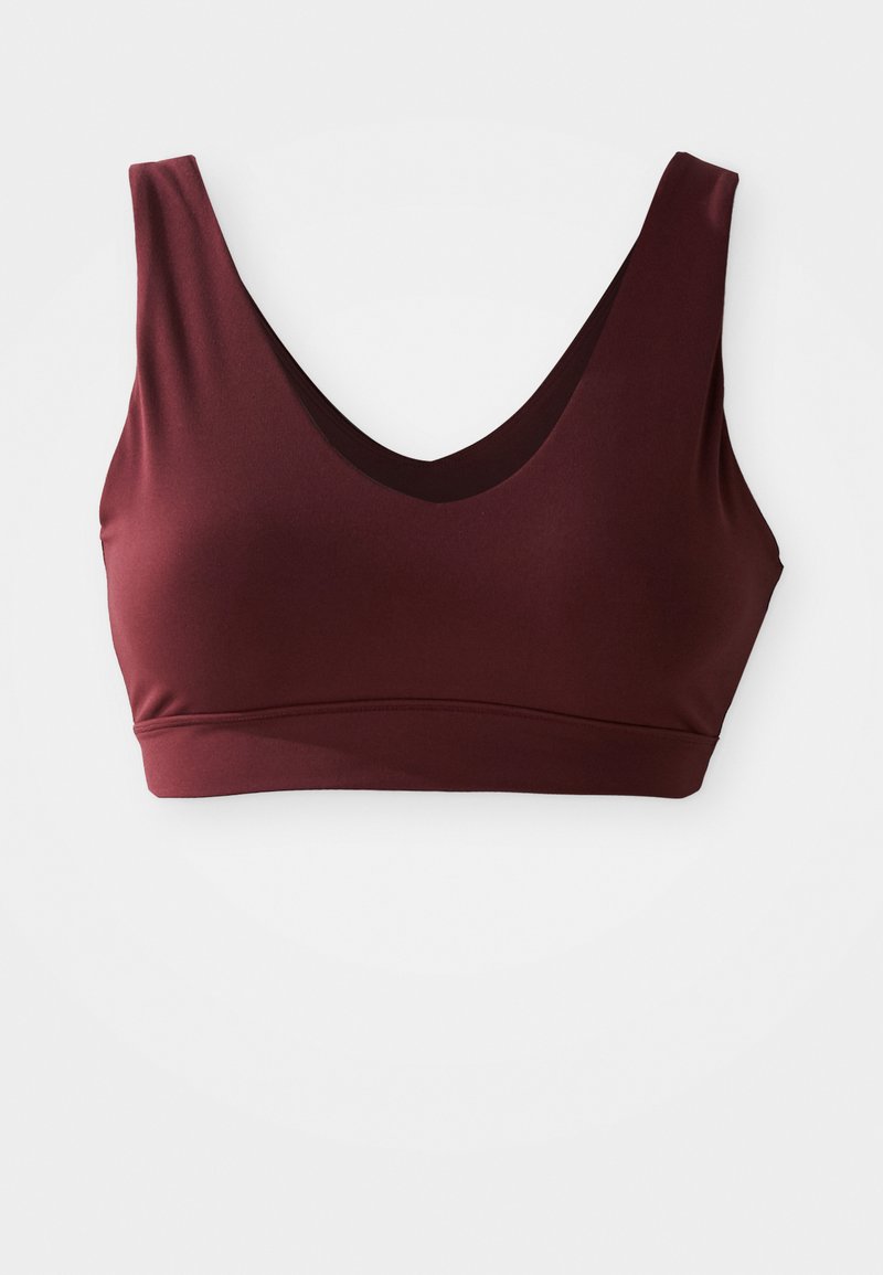 Sutiã desportivo em bordeaux com um decote em V profundo e alças largas, apresentado em tecido suave e elástico e um design sem costuras para conforto e suporte.