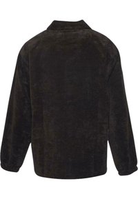 Black corduroy shirt jacket with a collar, long sleeves, and elastic cuffs. Features a textured surface and a relaxed silhouette.
