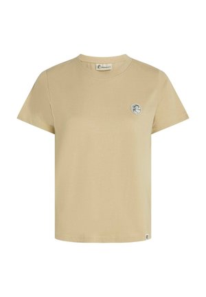Camiseta de algodón beige con cuello redondo, mangas cortas y un logo circular en el costado izquierdo del pecho. Textura suave con corte recto.