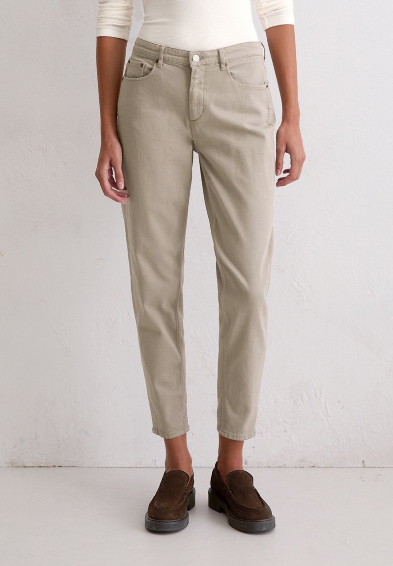Beige cotton trousers with a slim fit, five pockets, and a button closure, featuring a smooth texture and tailored hem at the ankle.