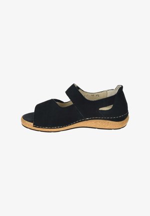 Black open-toe sandal with adjustable strap, cork wedge sole, and side cutouts, shown from the inner side.