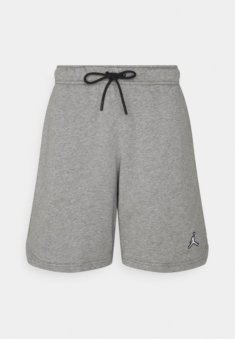 Shorts de sport gris avec cordon noir et petit logo Jumpman noir et blanc sur la partie inférieure de la jambe gauche sur fond blanc.