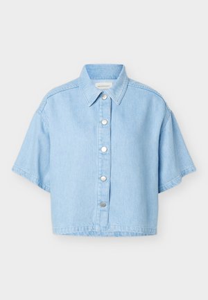 Light blue cropped denim shirt with short sleeves, pointed collar, and silver snap buttons down the front against a plain background.