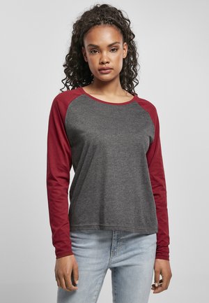 Long-sleeve T-shirt with a gray body and burgundy raglan sleeves, made of soft fabric, featuring a round neckline and relaxed fit.