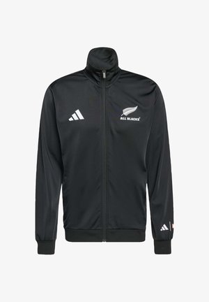 Zwarte zip-up jack gemaakt van glad synthetisch materiaal. Beschikt over een hoge kraag, wit logo en accenten op de schouders.