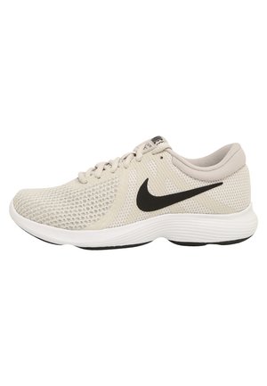 Light beige Nike running shoe with black swoosh, breathable mesh upper, cushioned white sole, and lace-up closure.