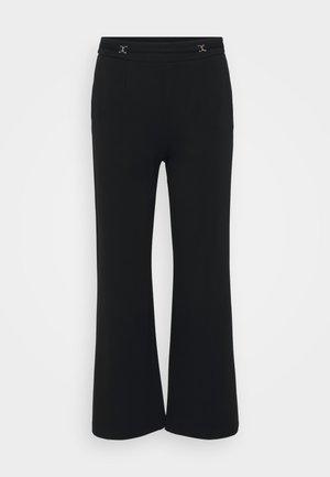 Black flared pants in soft fabric with a flat waistband featuring two decorative silver accents at the front, smooth texture and no pockets.