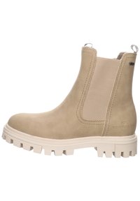 Bottine beige avec panneaux latéraux élastiques, en suède texturé, semelle extérieure blanche robuste et détail du logo à l'arrière.