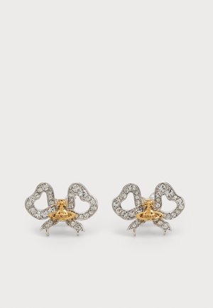 Silver crystal-studded bow-shaped earrings with small gold-tone planet-shaped embellishments at the center on a white background.