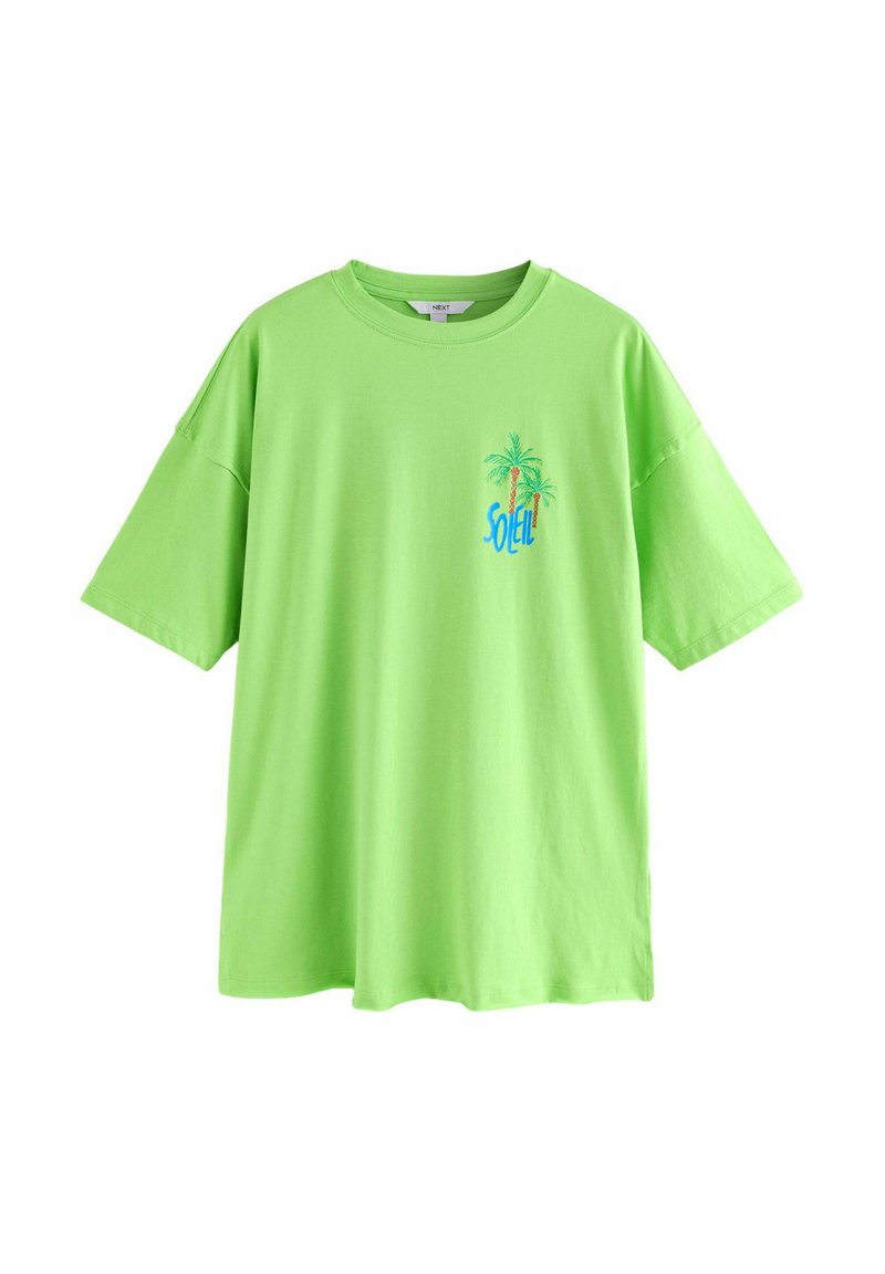 T-shirt oversize verde chiaro con maniche corte, collo rotondo e grafica di una palma con il testo "SOLEIL" in blu e arancione.