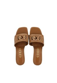 Bruine slip-on sandalen met een gladde leren afwerking, voorzien van een brede band versierd met een geometrisch logo en een platte zool.
