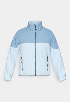 Hele sinine fliisjakks kõrge kraega, lukuga ja kontrastse siledat sinist kangast õlgadel. Omab kahte küljetaskut.