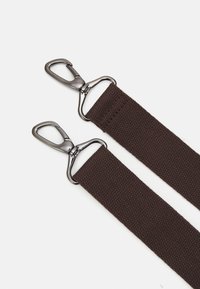 Brown woven straps with silver metal carabiners on each end. The straps feature a textured surface and sturdy hardware connections.