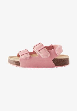 Sandal rosa realizzata in morbido camoscio, con due fibbie regolabili, una soletta in sughero e una suola in gomma testurizzata.