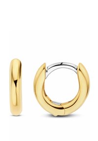 Guld hoop øreringe med en skinnende overflade, der har et tykt, buet design og en sølvlås til lukning. Teksturen er glat og refleksiv.