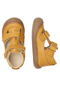 Żółte skórzane buty dla maluchów z dwoma rzepami. Okrągły czubek i teksturowana gumowa podeszwa zapewniająca przyczepność. Gładkie wykończenie wnętrza.