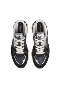 Black and gray athletic shoes with a mix of textured fabric and smooth synthetic material, featuring white laces and a beige sole. Silver accents visible.