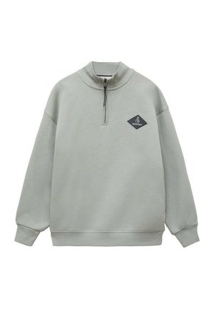 Felpa verde chiaro con zip metà, vestibilità ampia, polsini a coste e un logo a forma di diamante nero sul lato sinistro del petto.