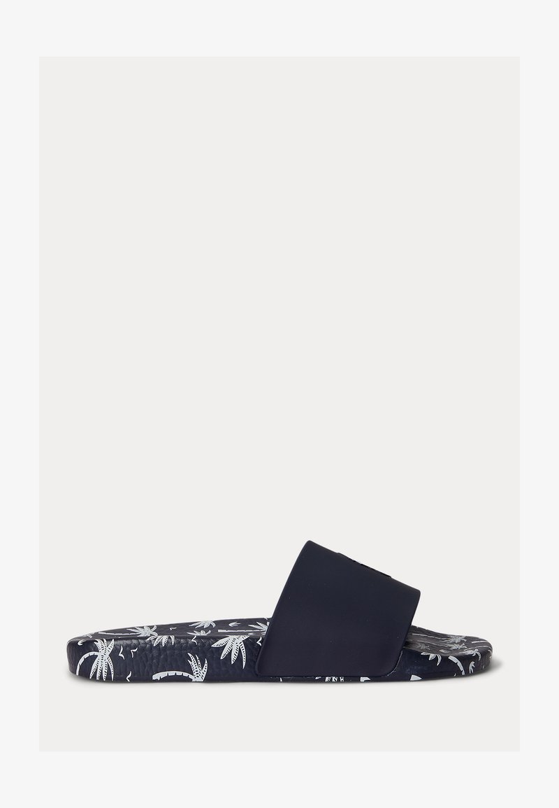Granatowy klapek na płaskiej podeszwie z szerokim paskiem i wzorem białych palm oraz tropikalnych liści na podeszwie.