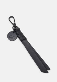 Černý kožený přívěsek na klíče s klipem a dvěma dlouhými, zužujícími se pásky. Obsahuje kulatou známku s ražbou "ALDO". Hladká textura.