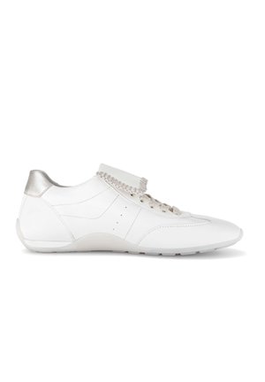 White leather sneaker with beige laces, scalloped tongue detail, and metallic silver heel accent.