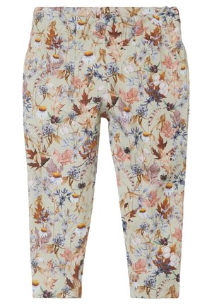 Leggings pastello morbide con un motivo floreale autunnale su tutta la superficie, caratterizzato da foglie, fiori e bacche in toni smorzati di marrone, viola e giallo.