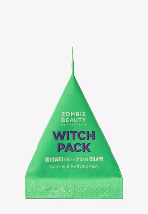 Confezione triangolare verde con etichetta "WITCH PACK" in testo viola audace, contenente una maschera viso calmante e purificante.
