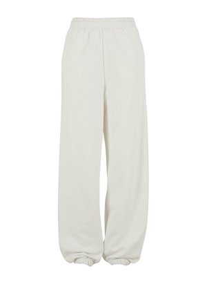 Cream-colored sweatpants with an elastic waistband and elasticized cuffs, featuring a relaxed fit and soft texture.