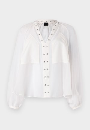 Blusa bianca con scollatura a V e chiusura con bottoni. Presenta maniche a palloncino, borchie argentate lungo il colletto e vita svasata. Tessuto morbido e trasparente.