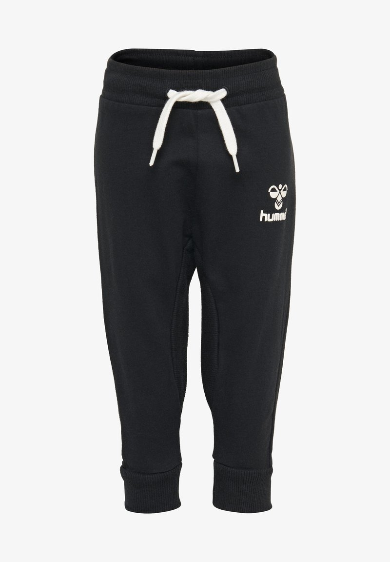 Pantalons de survêtement noirs avec des poignets côtelés et une ceinture élastique. Comprend un cordon blanc et un petit logo blanc sur la cuisse.