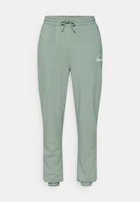 Jasnozielone dresy wykonane z miękkiego materiału, z elastycznym pasem i sznurkiem do wiązania oraz ściągaczami przy kostkach. Minimalistyczne logo.