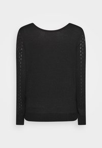 Svart tröja med rund halsringning, långa ärmar med texturerade, mönstrade detaljer längs sidorna, och en åtsittande ribbad nederkant.